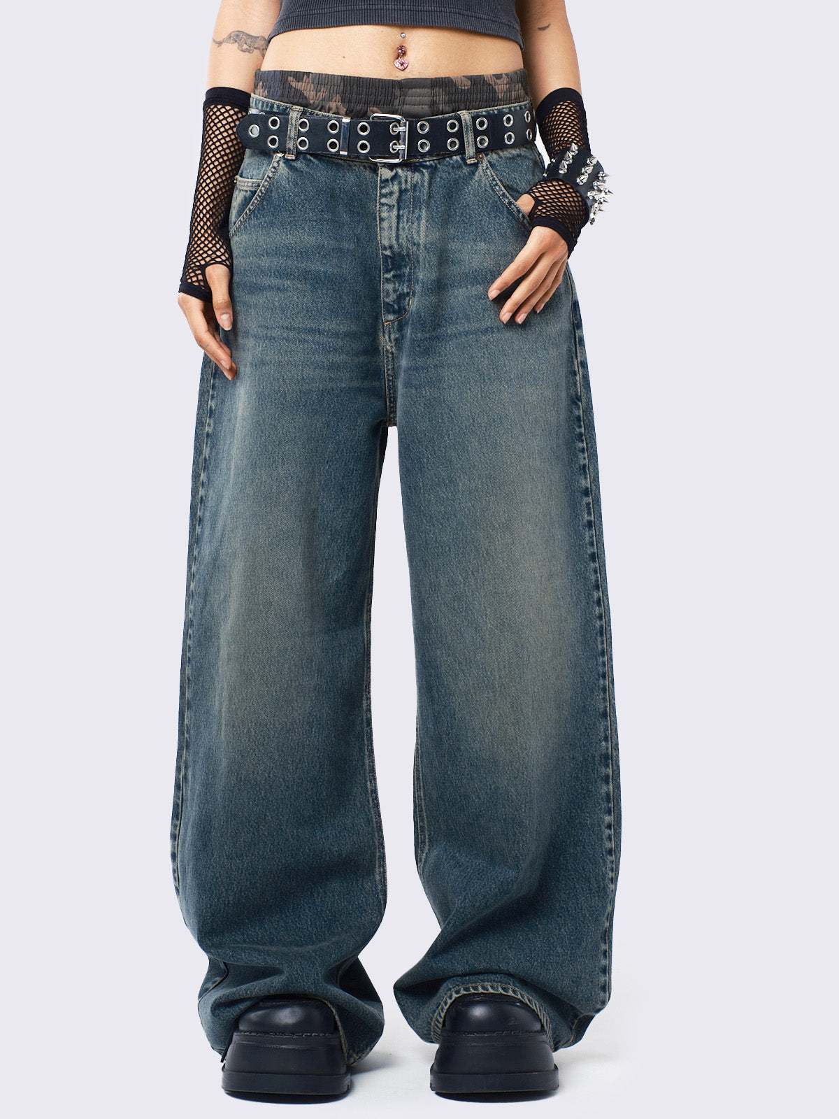 Baggy jeans in washed light blue with green overdye, Minga Star back embroidery, wide leg, regular waist, and relaxed fit. Y2K-inspired and grunge aesthetic.