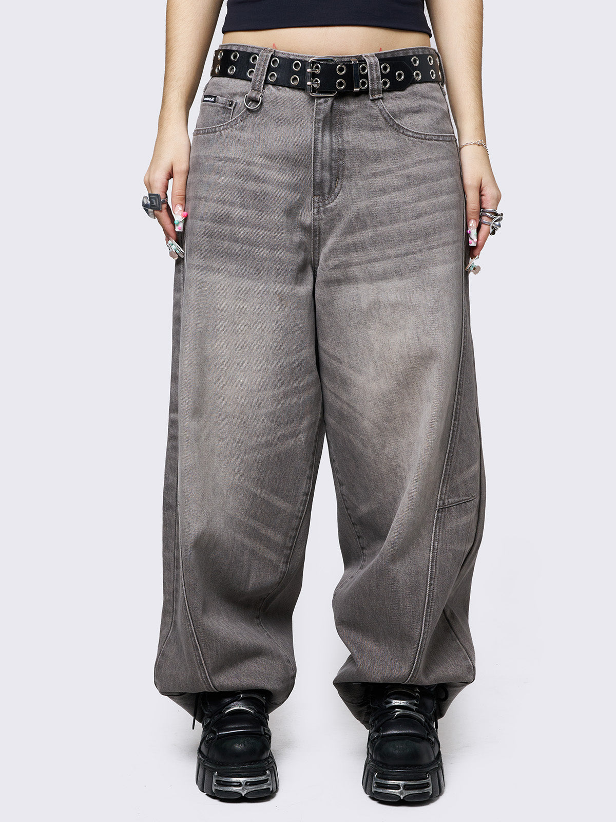 Grey washed super baggy jeans with a relaxed fit, regular waist, zip fly, button fastening, and belt loops. Trendy streetwear style.
