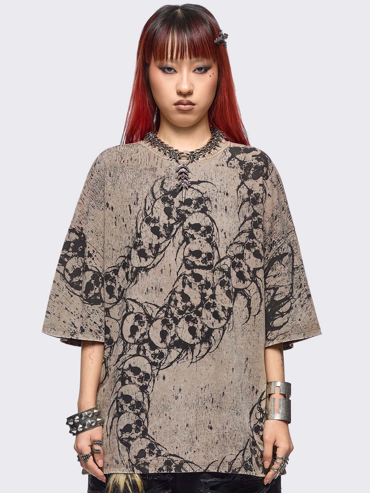 Beige oversize washed t-shirt featuring a skull centipede graphic front print.