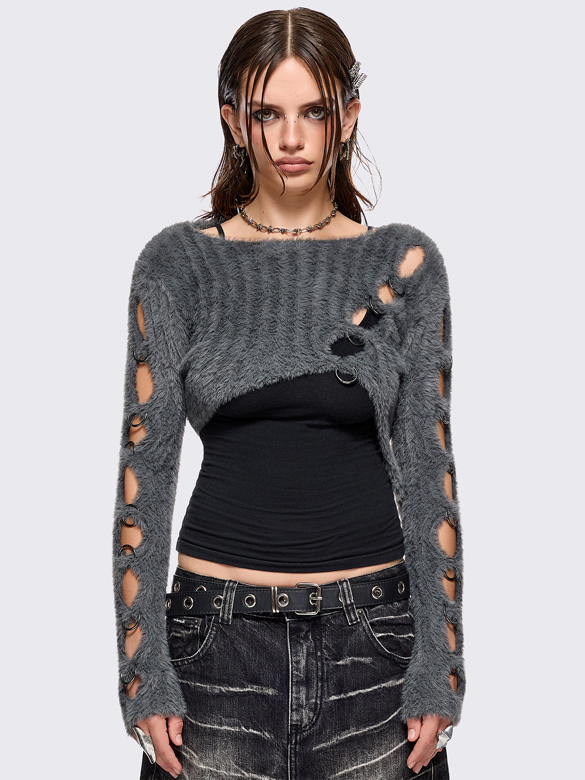 Grey fuzzy knitted sweater with cut-outs with metal ring hardware details.
Bolero asymmetric style.