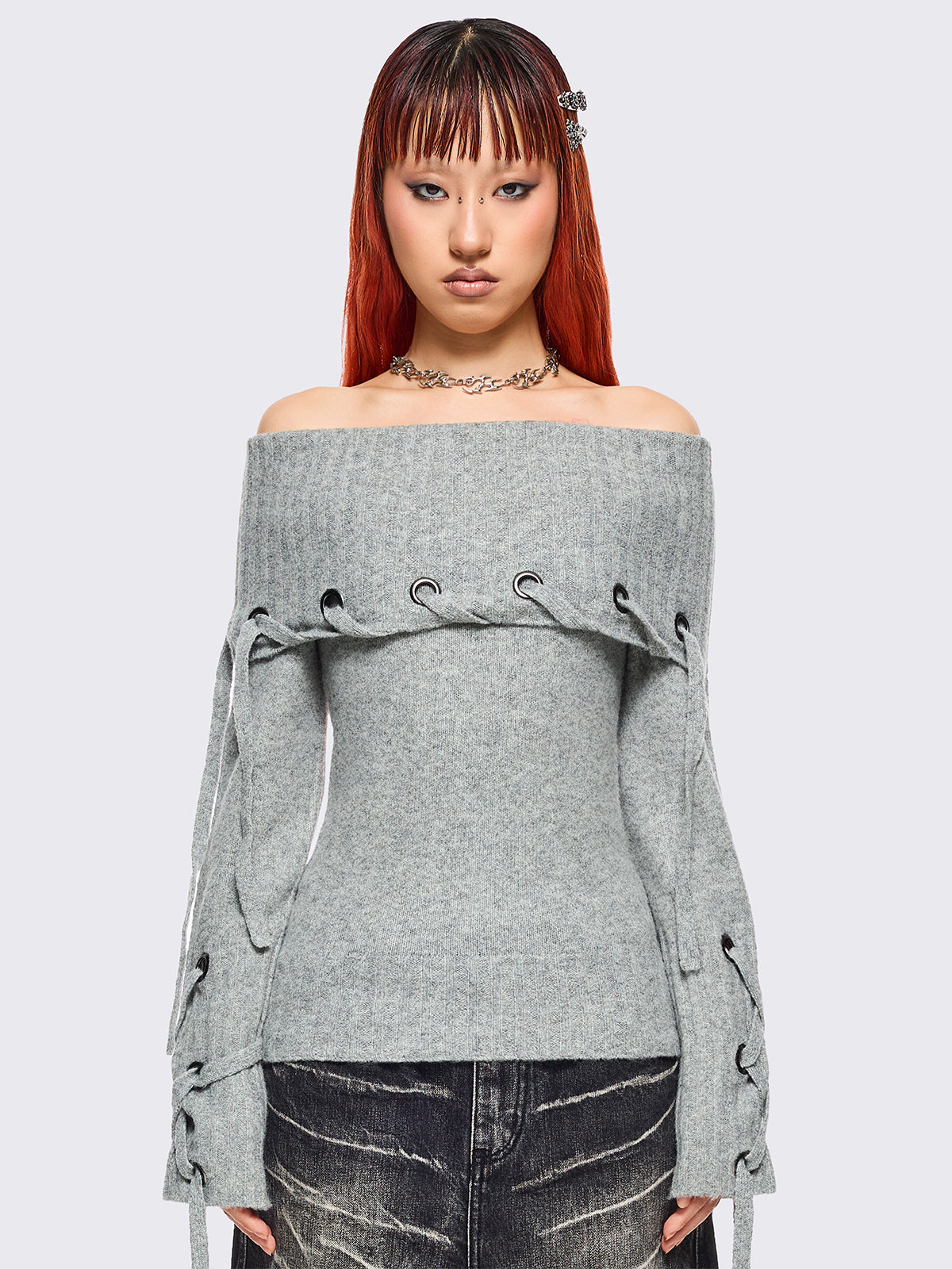 Grey off-shoulder knitted sweater with lace up details.