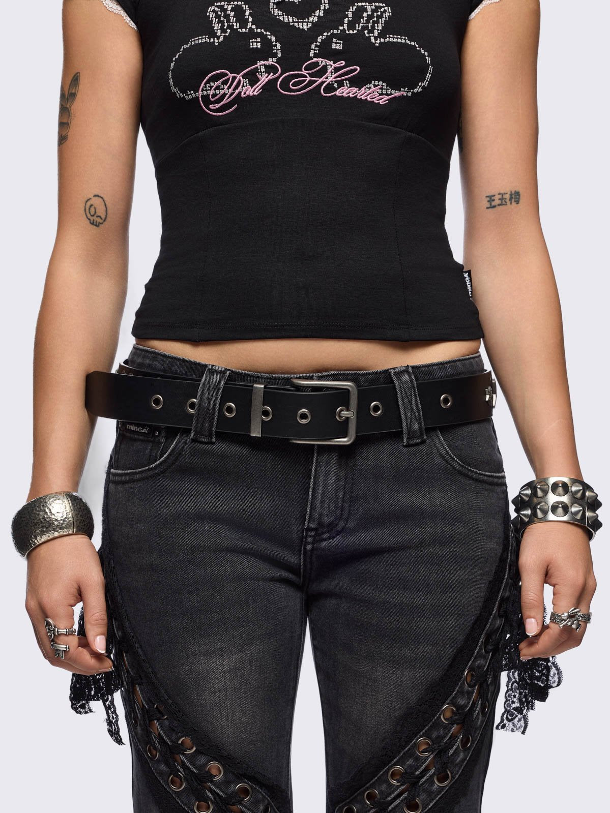 Black vegan leather belt featuring silver hardware and star details.
