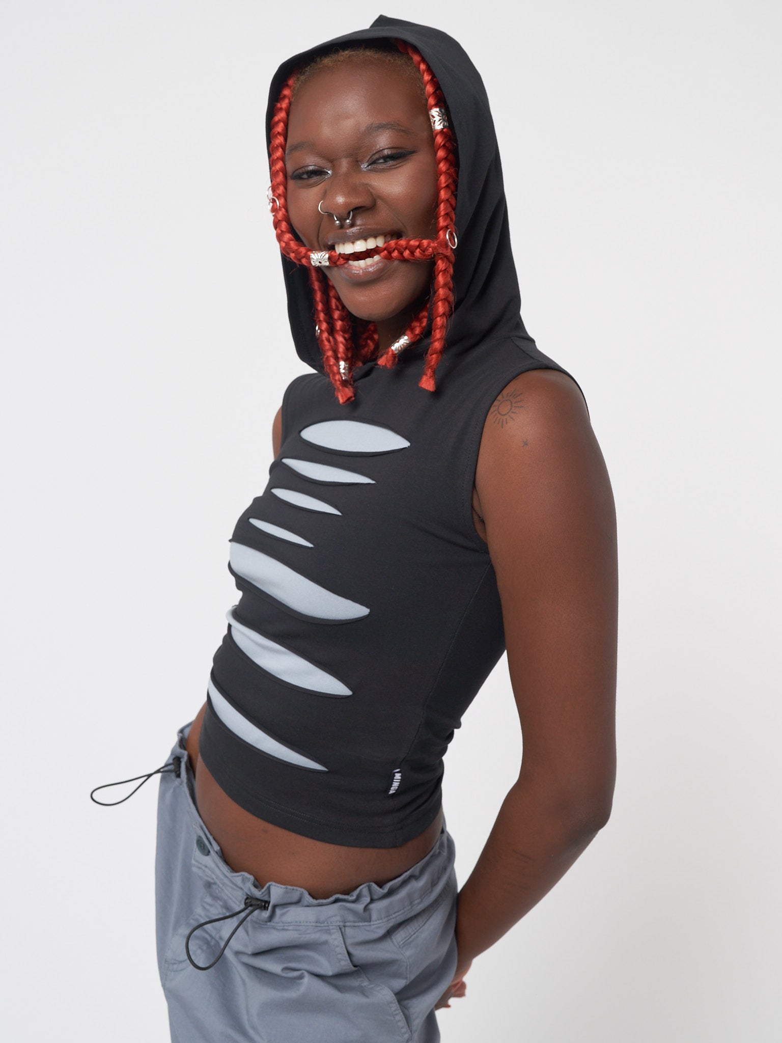 Slash hooded top in black featuring front contrast layer in grey-blue and cut-out panels