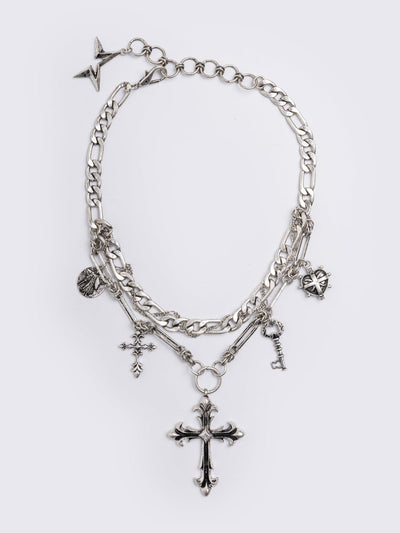 Silver chunky layered necklace featuring cross, key and medallion pendants.