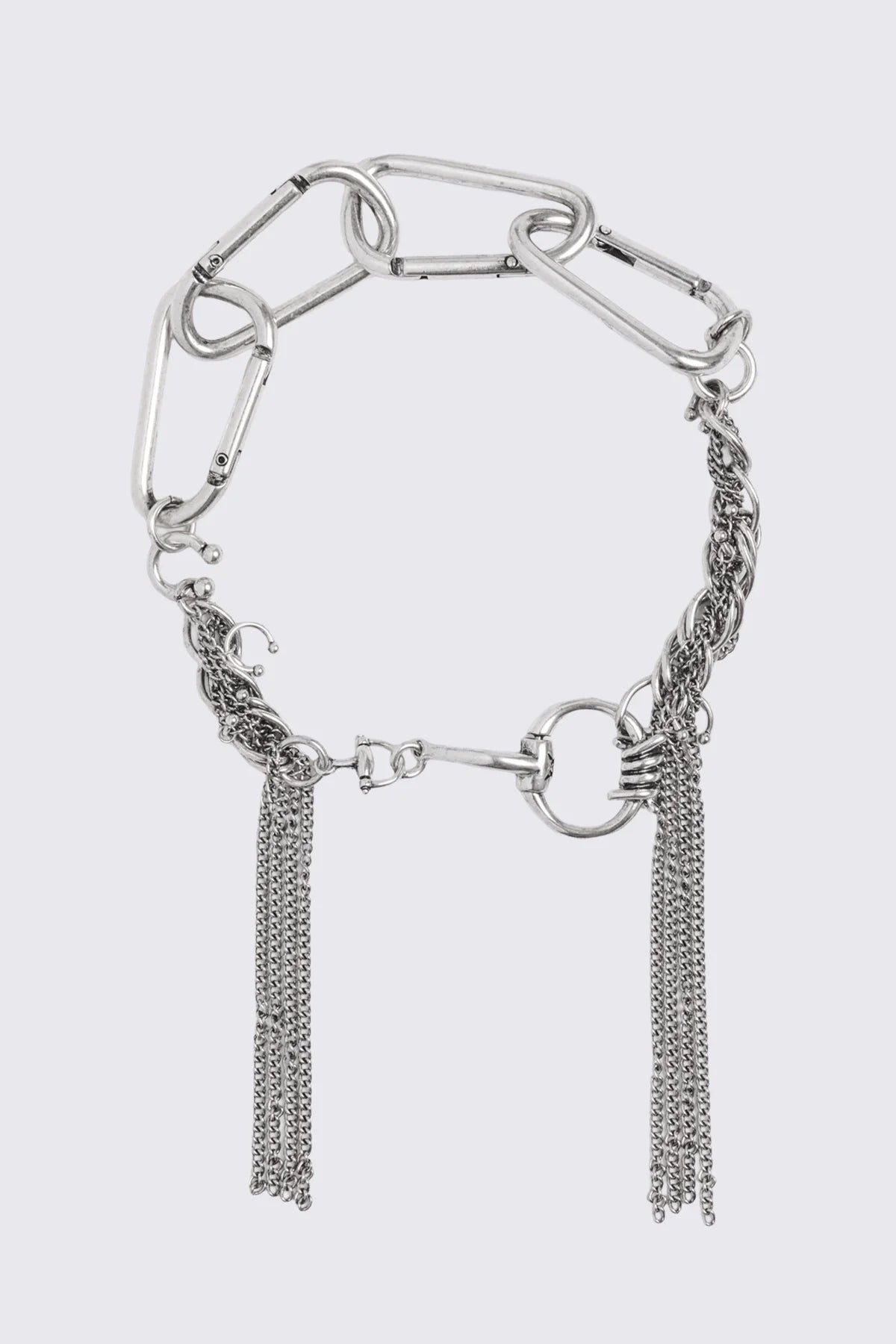 Asymmetrical necklace in antique silver with carabiner links, horsebit detail, and chain tassels in a grunge style.
