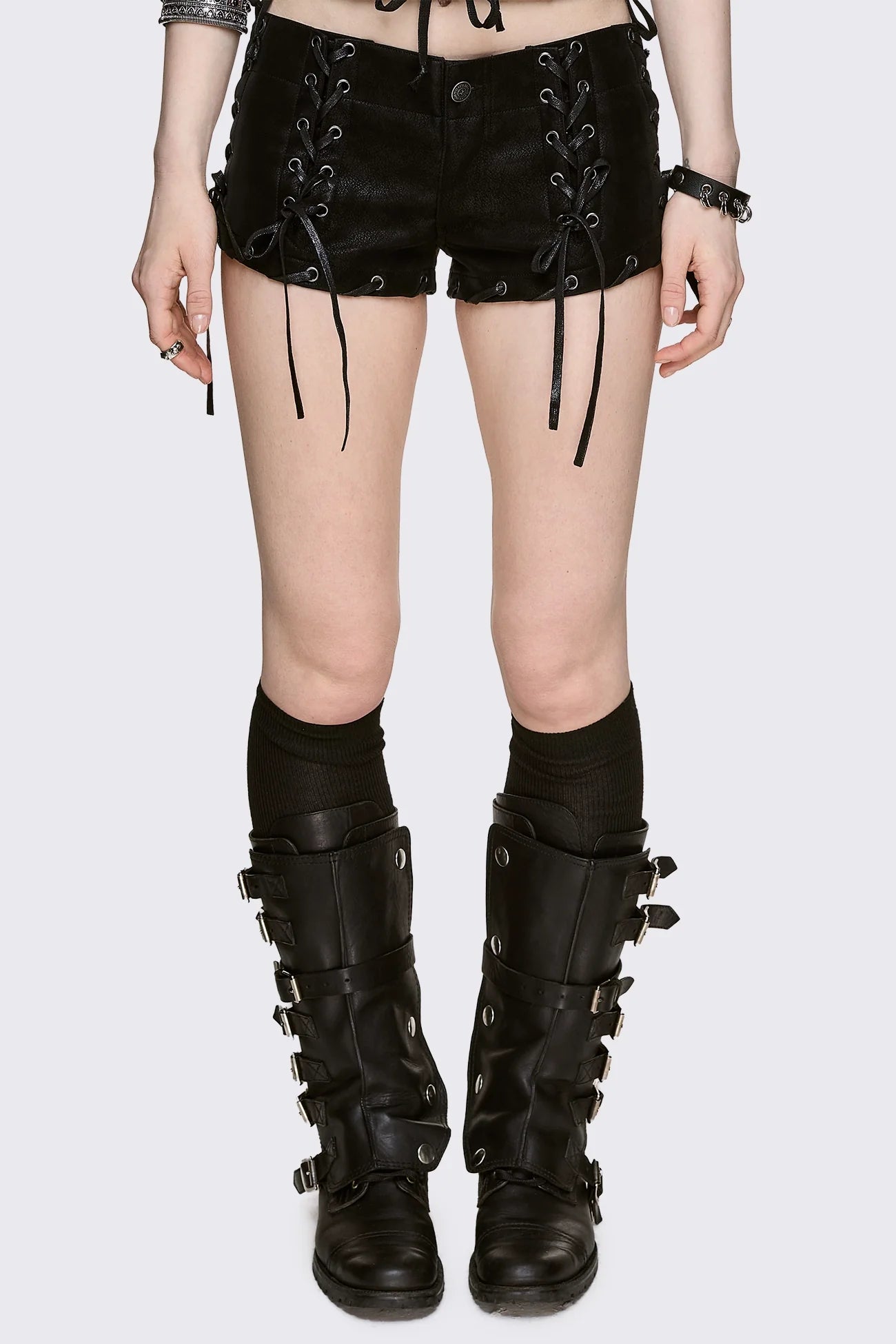 Black vegan suede micro shorts with front and side lace-up details, low-rise fit in a grunge goth style.