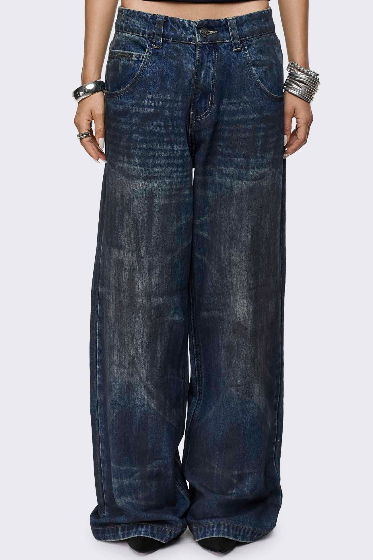 Indigo blue baggy wide leg jeans with dirty wash, whisker creases, regular waist and five-pocket design.