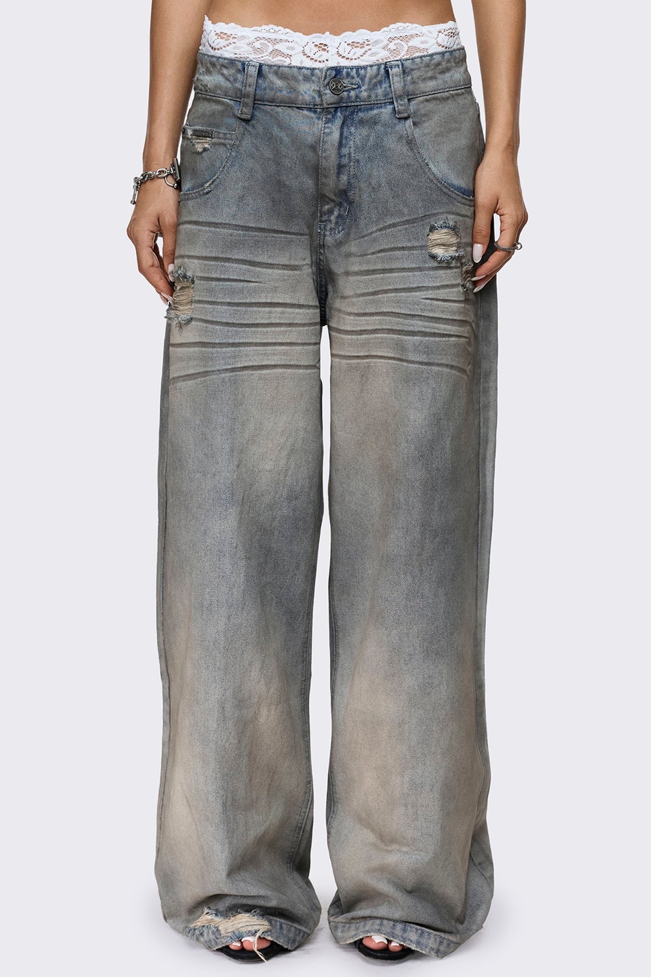 Dirty light blue distressed jeans with faded wash, low-rise waist, straight baggy leg and five-pocket design.