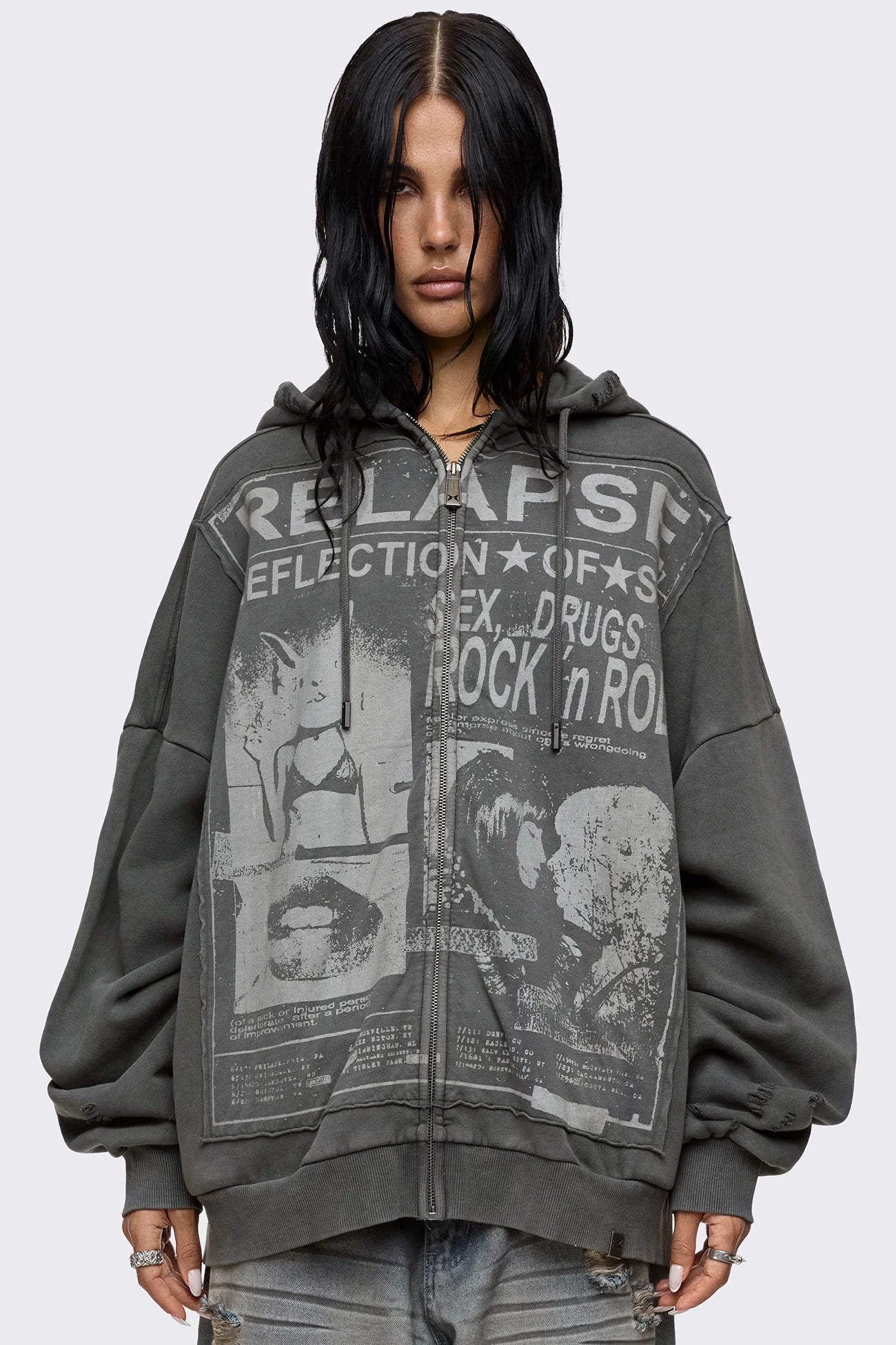 Grey washed zip up hoodie with Relapse graphic print, distressed details and oversized fit on model.
