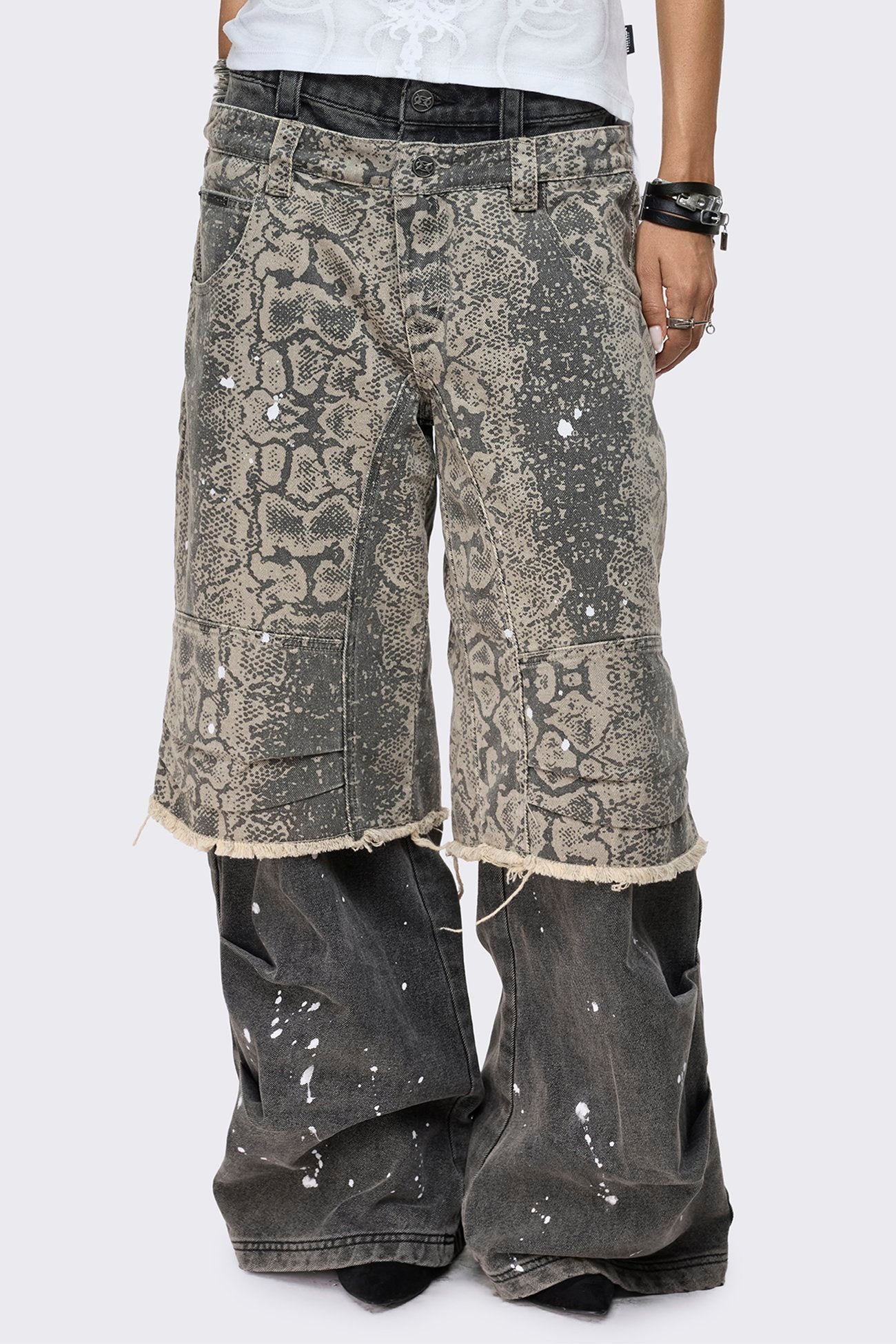 Grey snake print layered baggy jeans with paint splatter, low rise waist, wide leg fit and frayed raw hem.
