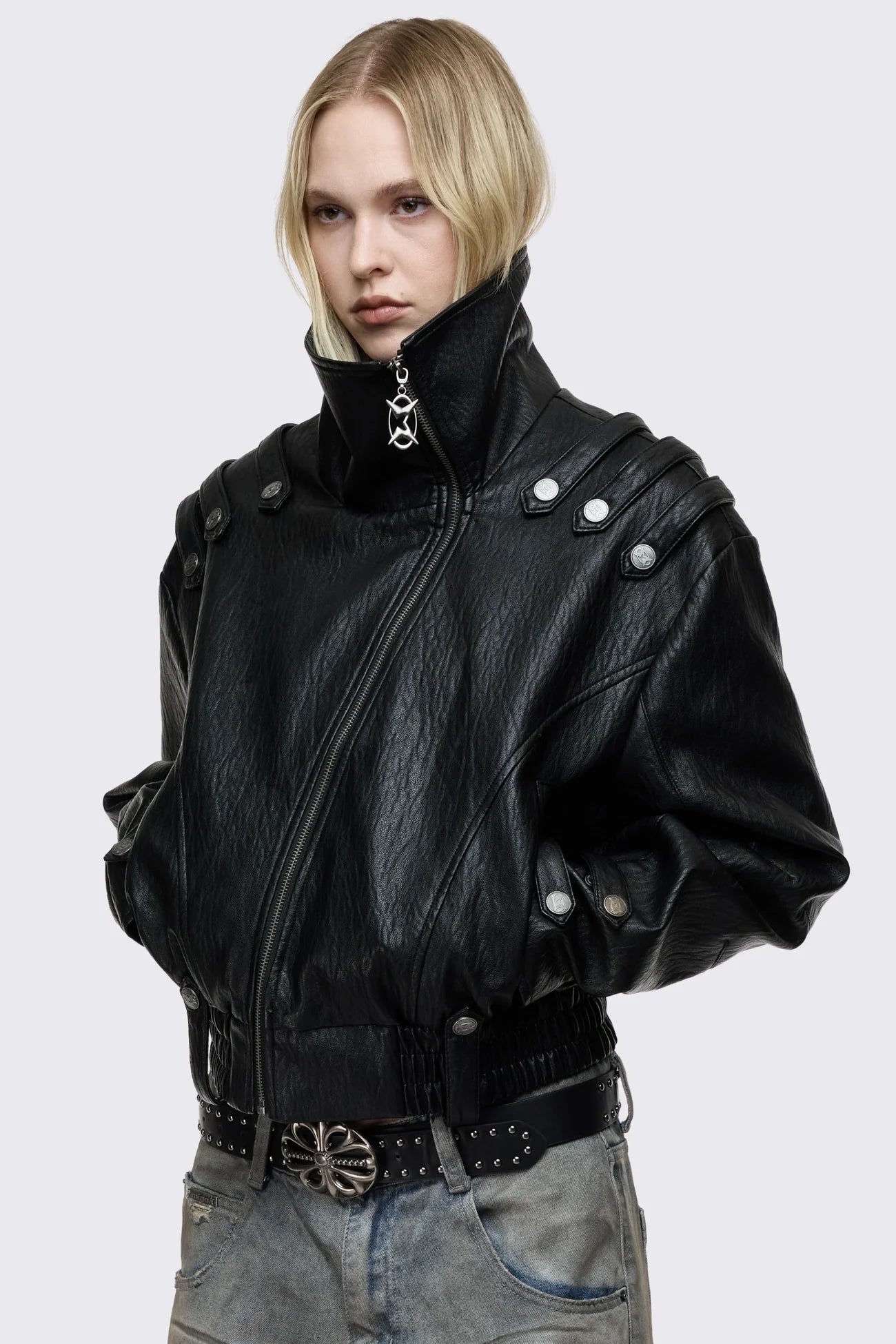 Black faux leather bomber jacket with military shoulder details, wide lapel collar, asymmetric zip and oversized fit.