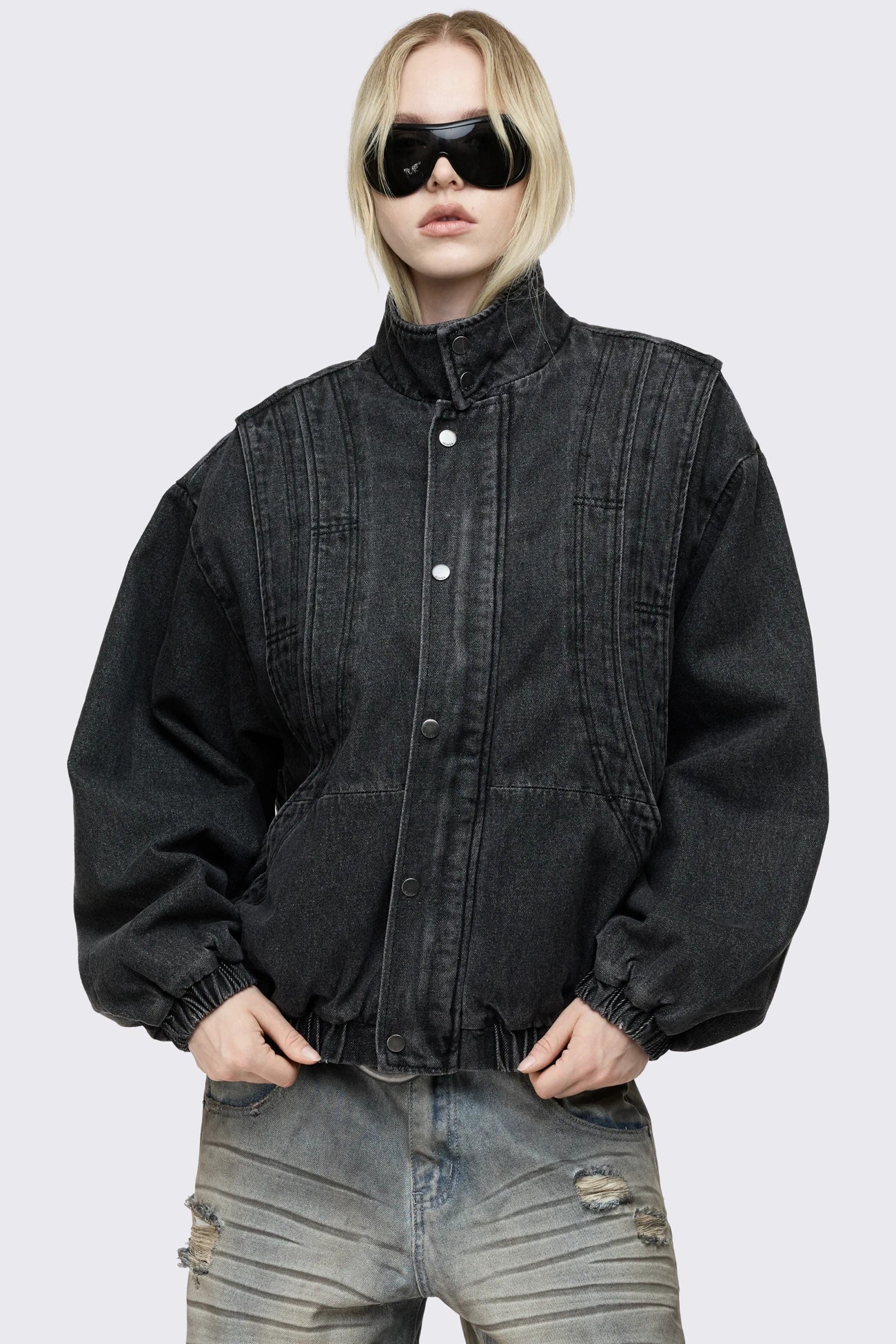 Black washed denim bomber jacket with layered detail, high collar, snap buttons, side pockets and an oversized fit.
