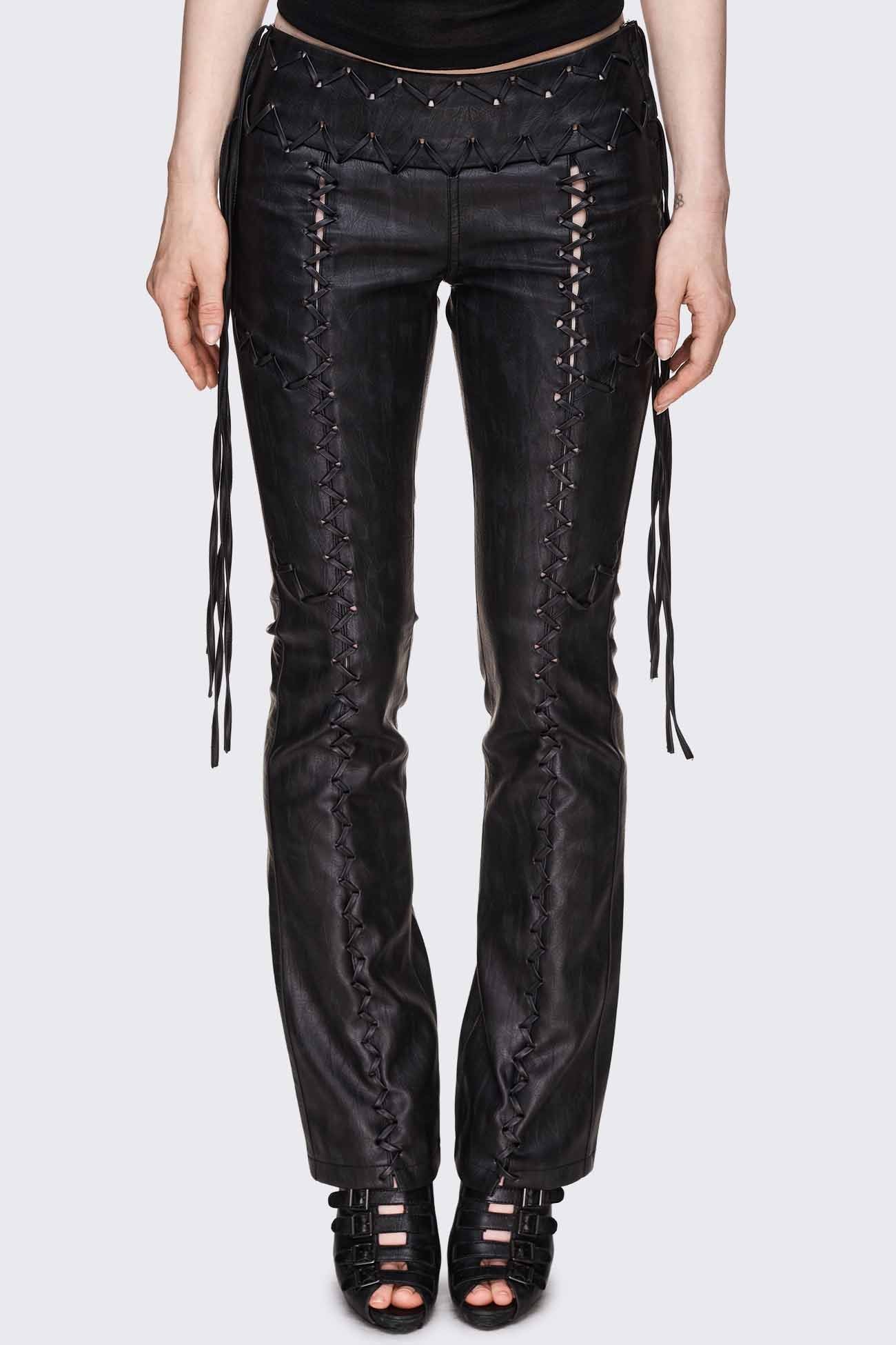 Black faux leather pants with lace-up panels, whipstitched low-rise waistband, trailing ties and flared leg.