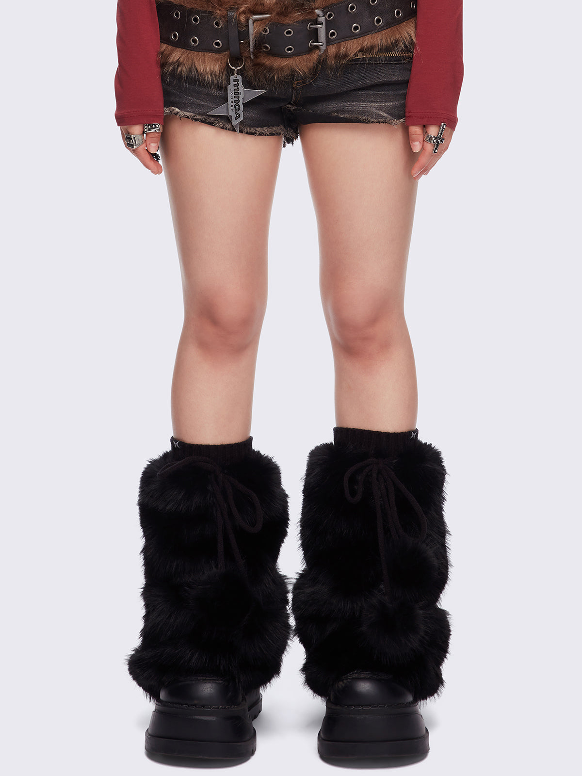 Black faux fur flared leg warmers with pom pom drawstring.