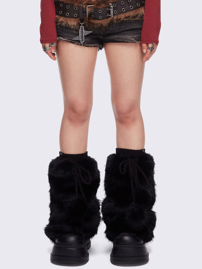 Black faux fur flared leg warmers with pom pom drawstring.