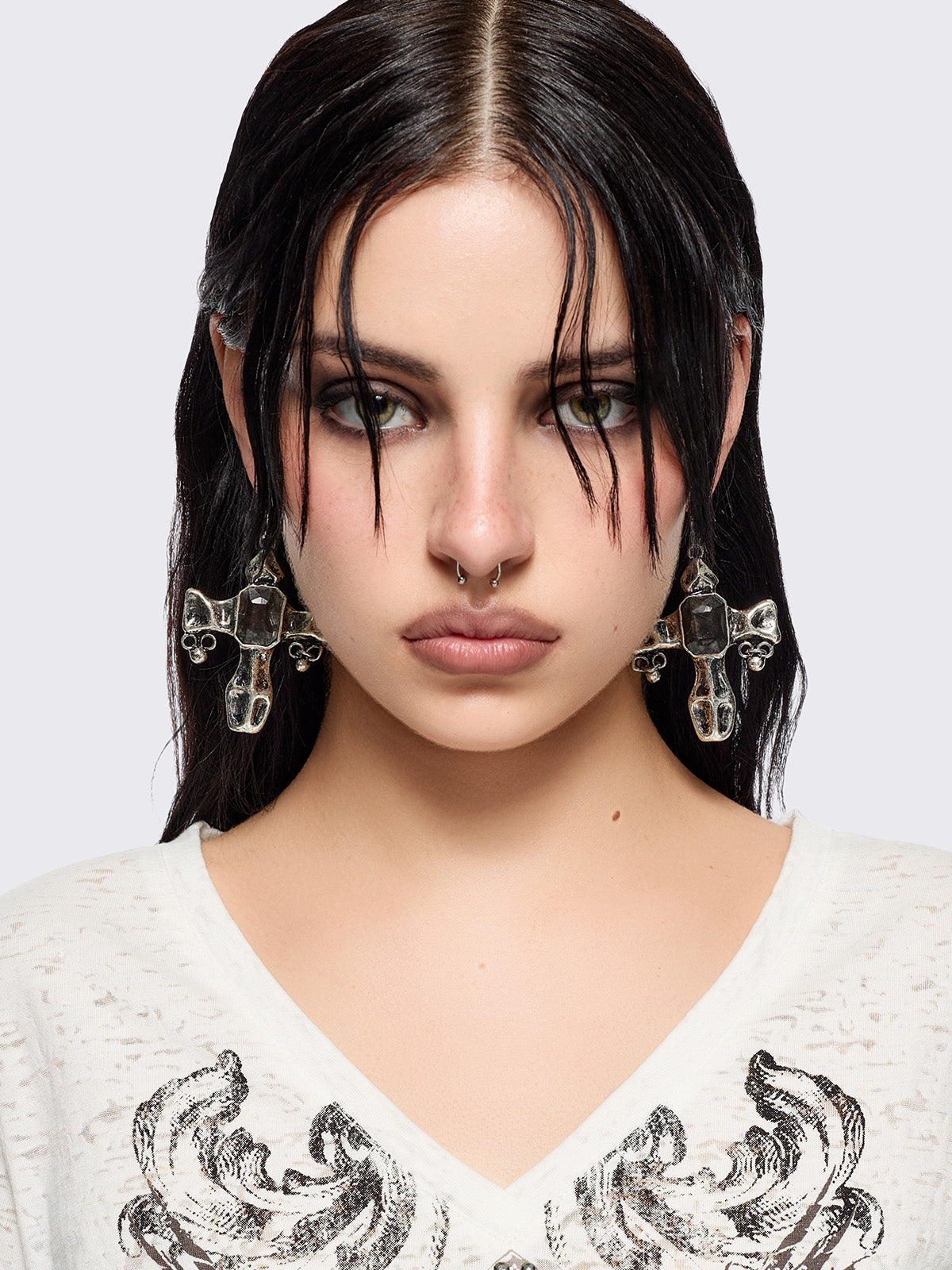 Pair of silver cross-shaped earrings with embedded stones 