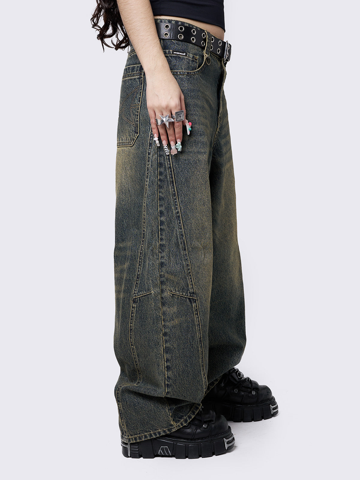 Blue washed super baggy jeans with green overdye, a relaxed fit, regular waist, zip fly, button fastening, and belt loops. Trendy streetwear style.