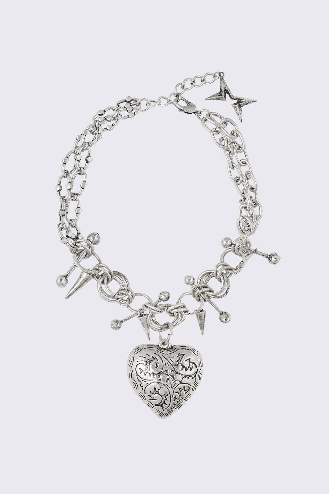 Silver chunky charm necklace with 3D heart pendant and bold metal piercing and spike details.