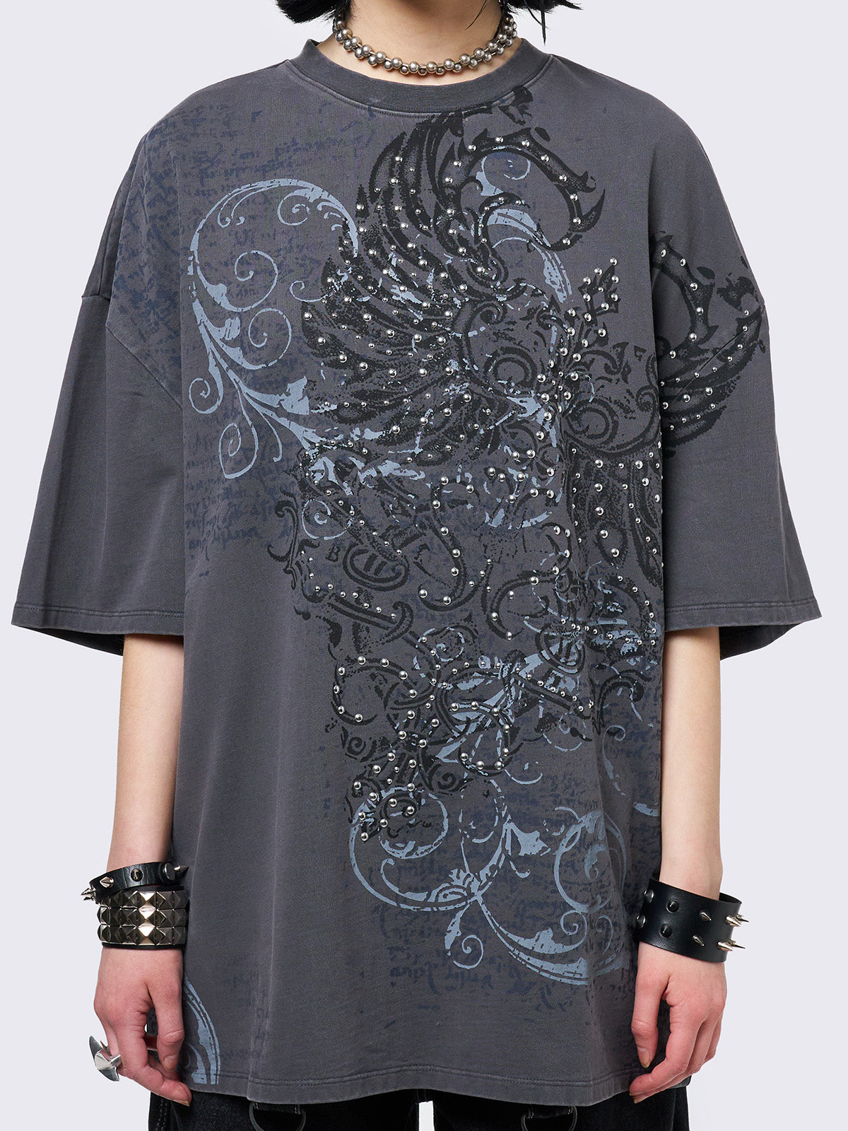 Grey washed t-shirt with grunge graphic front print featuring studded details. 