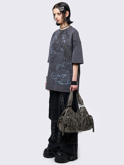 Grey washed t-shirt with grunge graphic front print featuring studded details. 
