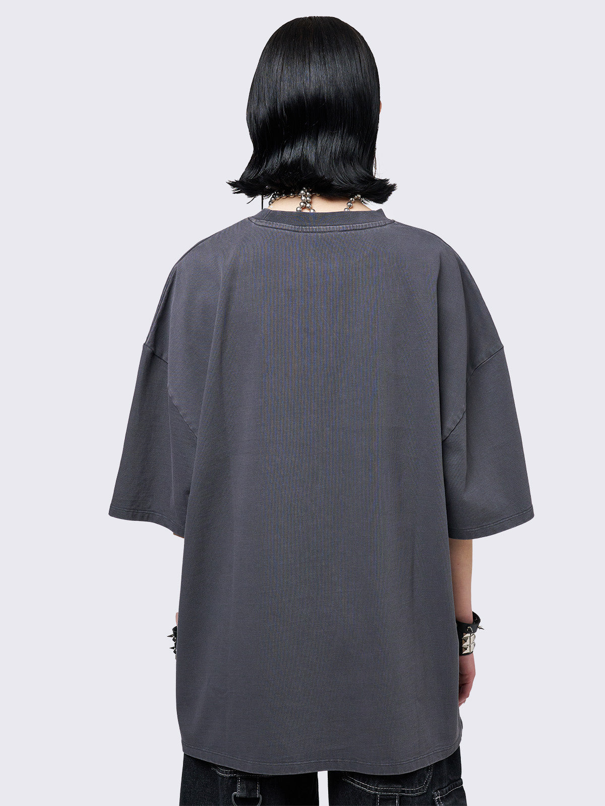Grey washed t-shirt with grunge graphic front print featuring studded details. 