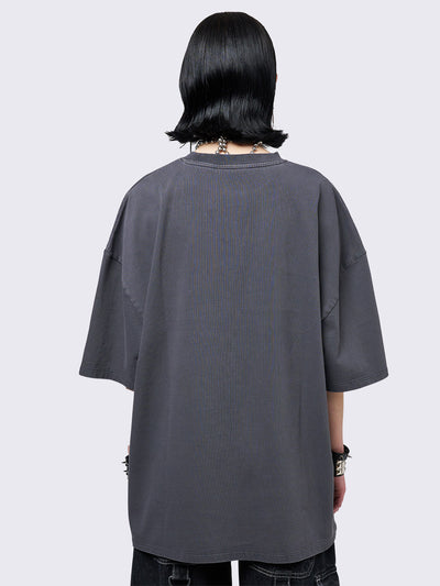 Grey washed t-shirt with grunge graphic front print featuring studded details. 