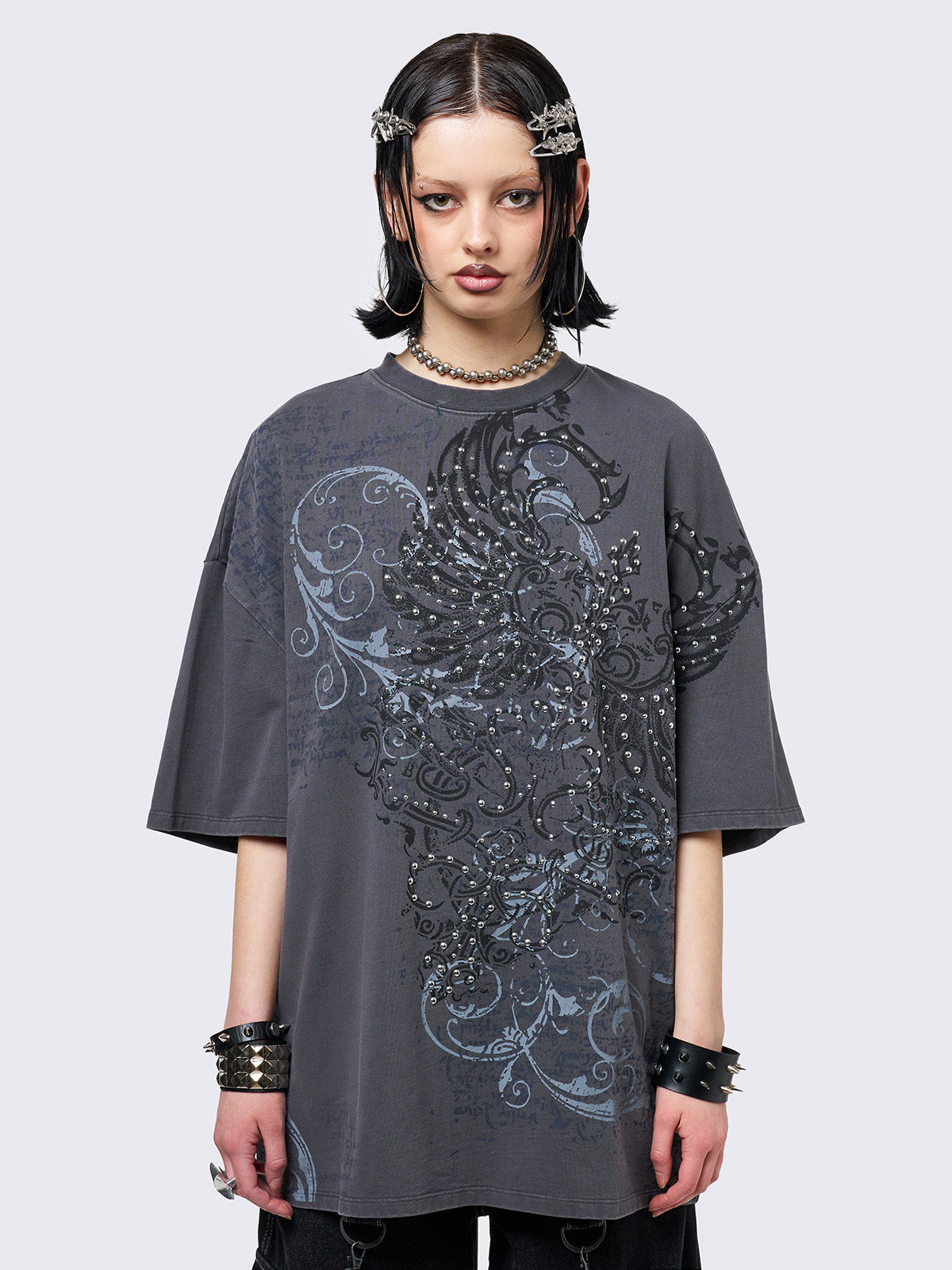 Grey washed t-shirt with grunge graphic front print featuring studded details. 