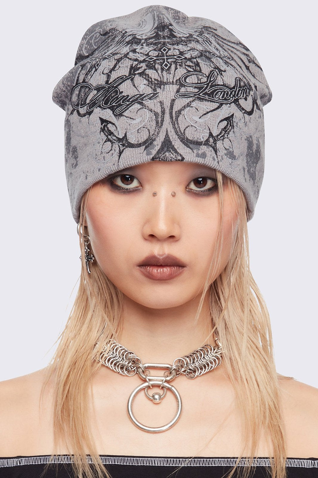 Grey beanie hat with grunge graphic print.