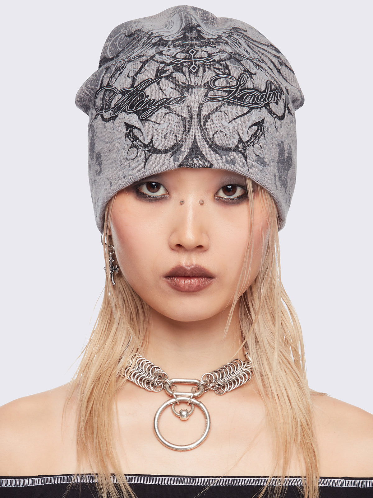Grey beanie hat with grunge graphic print.