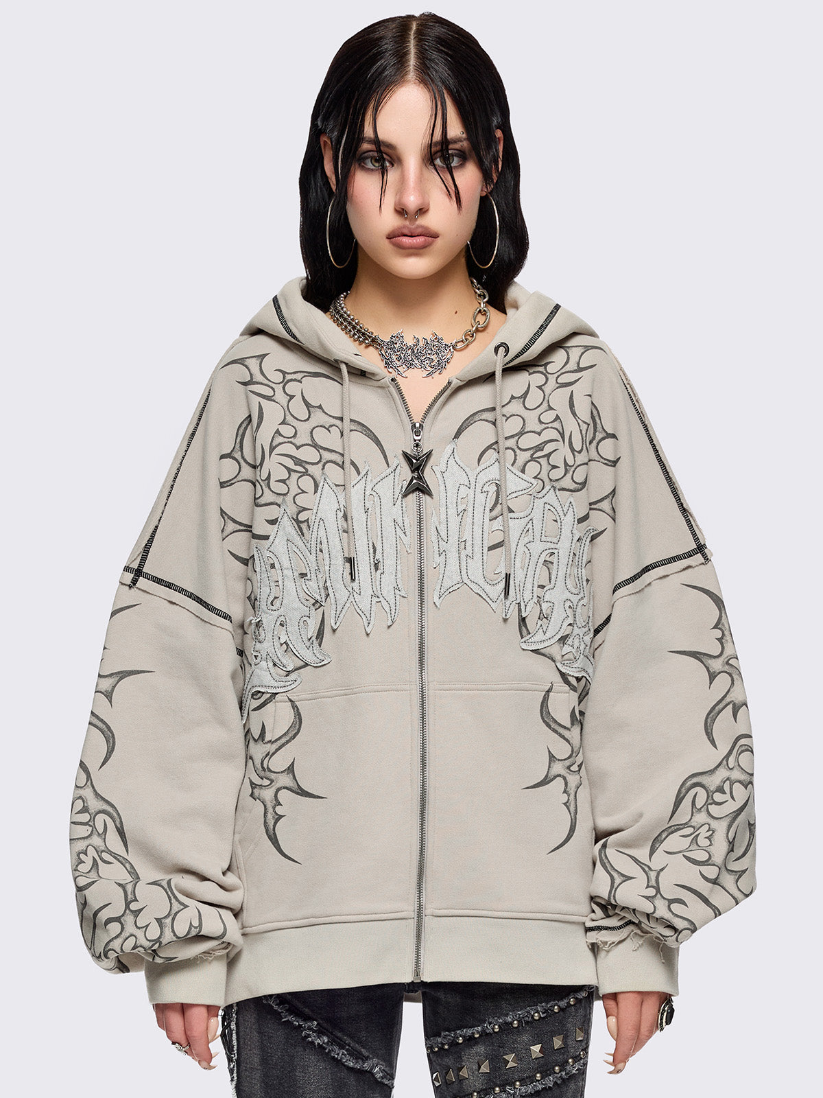 Bone beige zip up hoodie jacket featuring a black tribal sigilism graphic front and sleeves print, "Minga" embroidered patch and black contrast stitching.