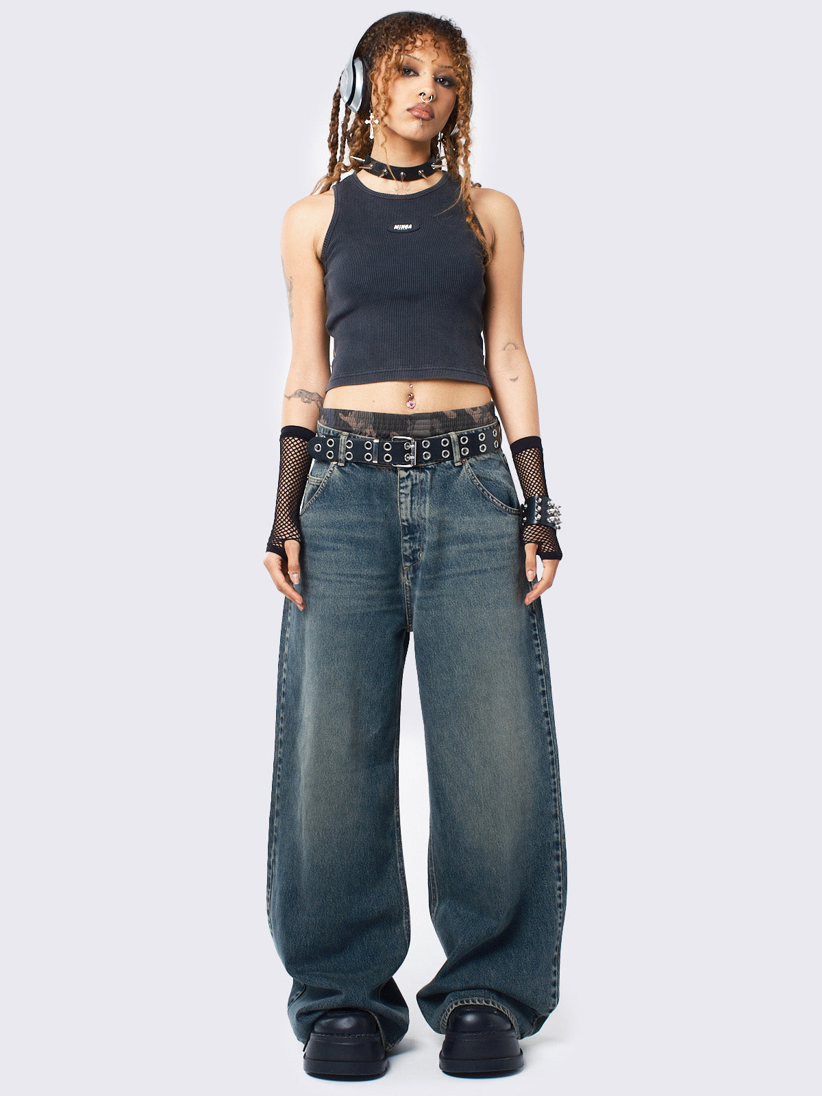 Baggy jeans in washed light blue with green overdye, Minga Star back embroidery, wide leg, regular waist, and relaxed fit. Y2K-inspired and grunge aesthetic.