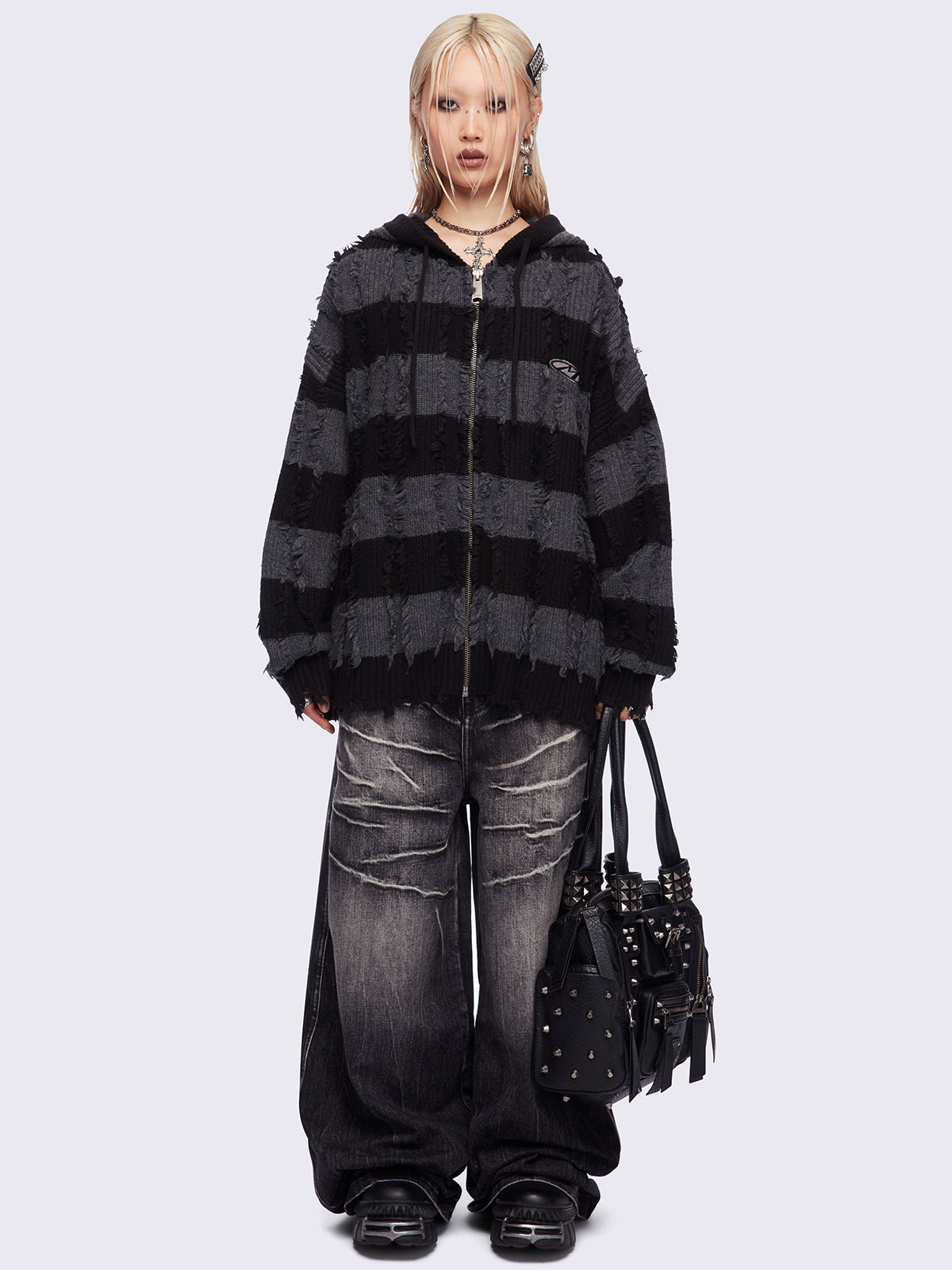 Hooded chunky knit cardigan in black and grey stripes with distressed details.