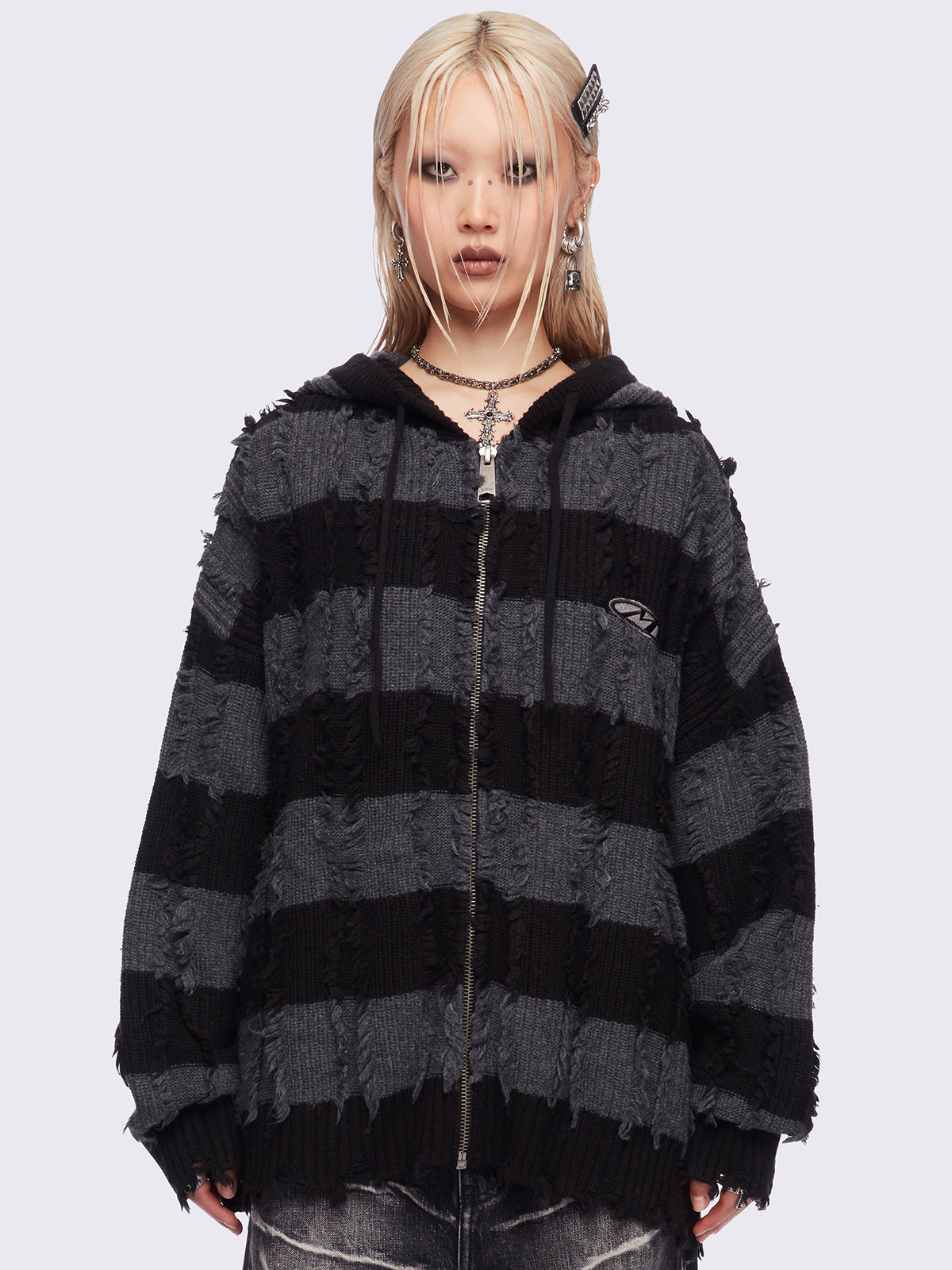 Hooded chunky knit cardigan in black and grey stripes with distressed details.