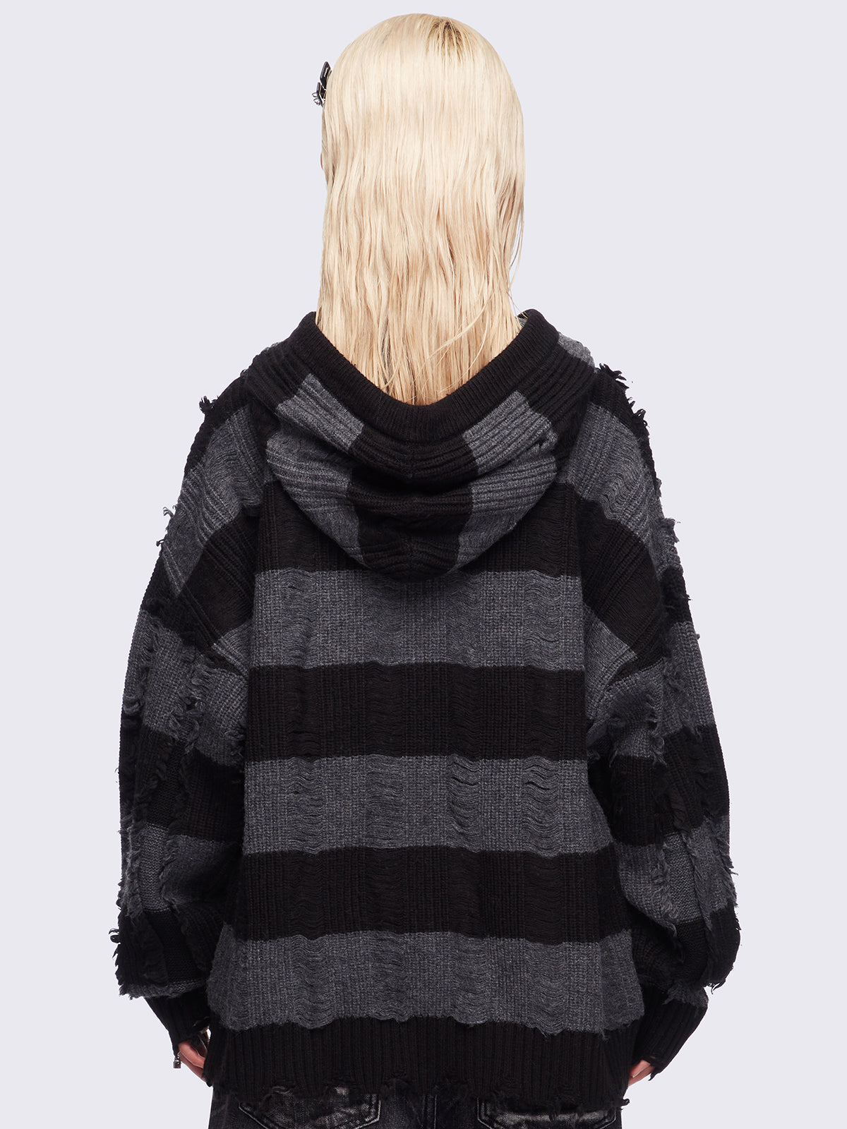 Hooded chunky knit cardigan in black and grey stripes with distressed details.