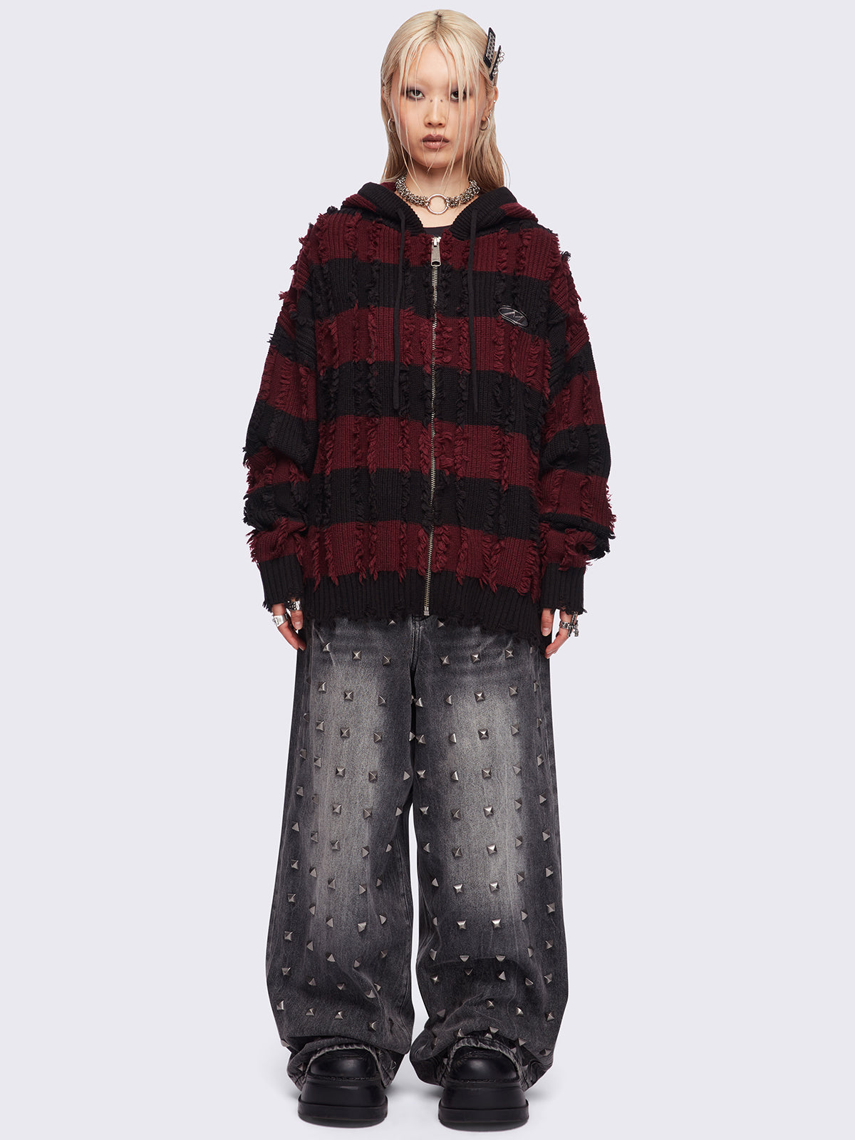 Hooded chunky knit cardigan in black and red stripes with distressed details.