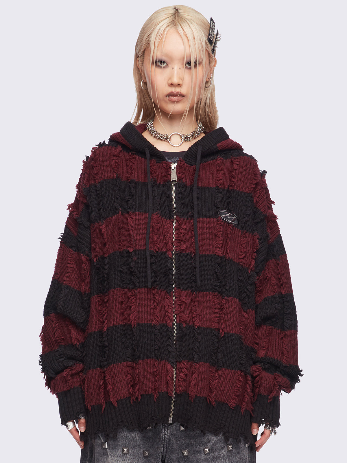Hooded chunky knit cardigan in black and red stripes with distressed details.