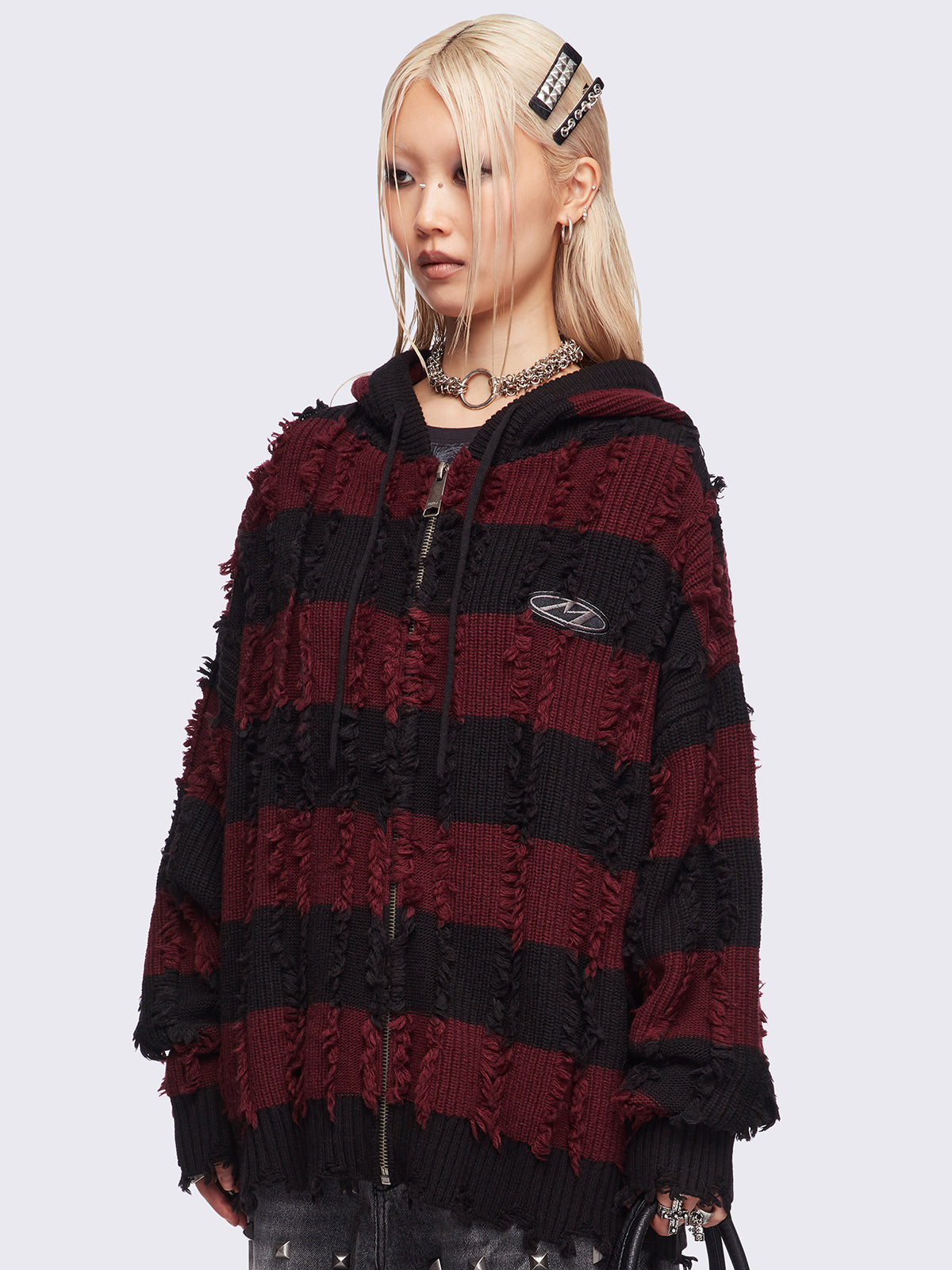 Hooded chunky knit cardigan in black and red stripes with distressed details.