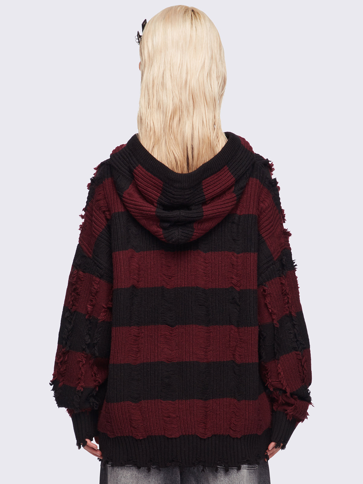 Hooded chunky knit cardigan in black and red stripes with distressed details.