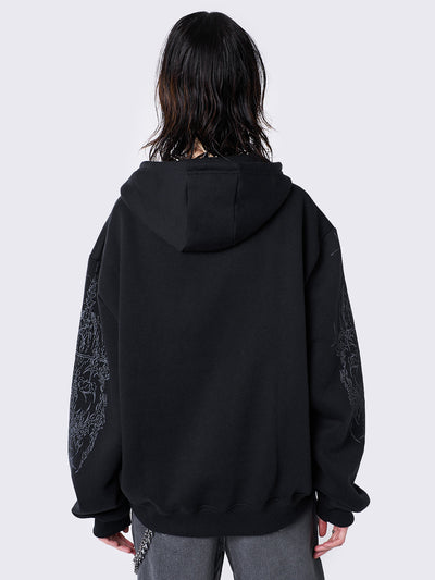 Oversized black zip-up hoodie with grunge graphic prints, drawstring hood, and ribbed trims. Y2K and acubi-inspired streetwear.