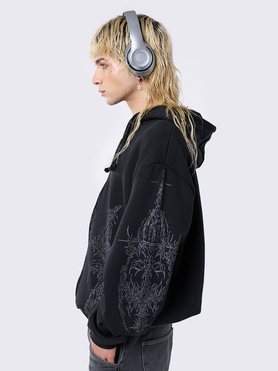 Oversized black zip-up hoodie with grunge graphic prints, drawstring hood, and ribbed trims. Y2K and acubi-inspired streetwear.