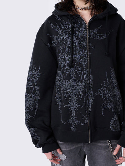 Oversized black zip-up hoodie with grunge graphic prints, drawstring hood, and ribbed trims. Y2K and acubi-inspired streetwear.