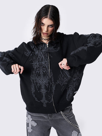 Oversized black zip-up hoodie with grunge graphic prints, drawstring hood, and ribbed trims. Y2K and acubi-inspired streetwear.
