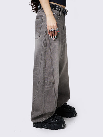 Grey washed super baggy jeans with a relaxed fit, regular waist, zip fly, button fastening, and belt loops. Trendy streetwear style.