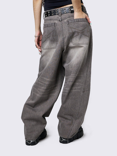 Grey washed super baggy jeans with a relaxed fit, regular waist, zip fly, button fastening, and belt loops. Trendy streetwear style.