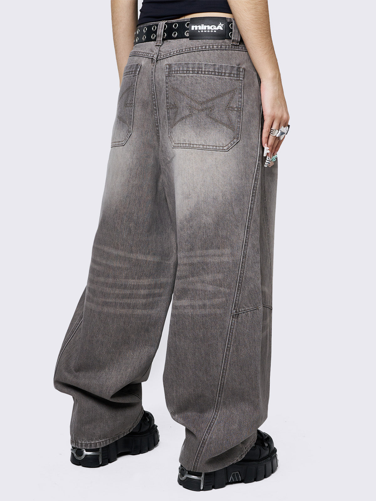 Grey washed super baggy jeans with a relaxed fit, regular waist, zip fly, button fastening, and belt loops. Trendy streetwear style.