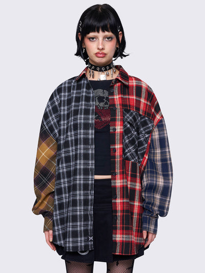 Patchwork shirt with multi-colored plaid panels, front button placket, chest pocket, spread collar, long sleeves, and a loose fit for a relaxed style.