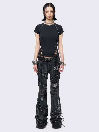 Black baby tee with adjustable lace-up sides and eyelet details. Grunge-inspired style. 