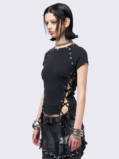 Black baby tee with adjustable lace-up sides and eyelet details. Grunge-inspired style. 
