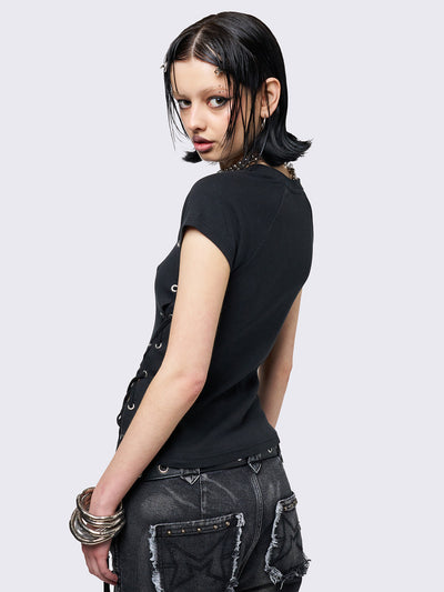 Black baby tee with adjustable lace-up sides and eyelet details. Grunge-inspired style. 