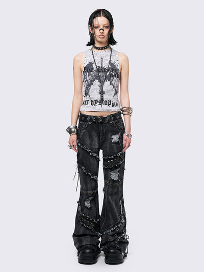 Black washed flare jeans with stud, eyelet, lace-up, and distressed details. Grunge-inspired look.